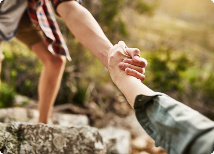 alone-we-climb-rocks-together-we-climb-mountains-cropped-shot-hikers-helping-each-other-climb-up-rock-nature