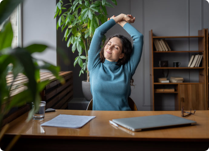 joyful-woman-stretching-relaxed-with-closed-eyes-enjoy-break-after-work-done-sit-with-closed-laptop